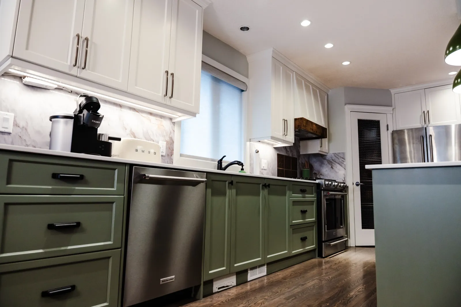 Custom wood kitchen cabinetry and white stone countertops in a spacious Calgary kitchen renovation