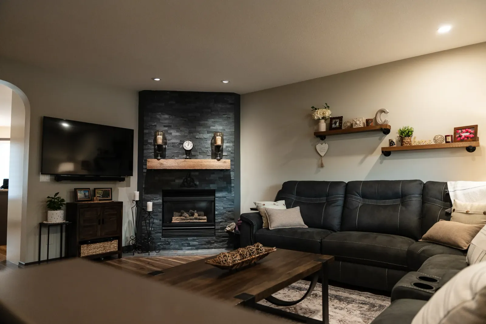 Stone accents add rich texture to this luxury living room in a complete Calgary home renovation