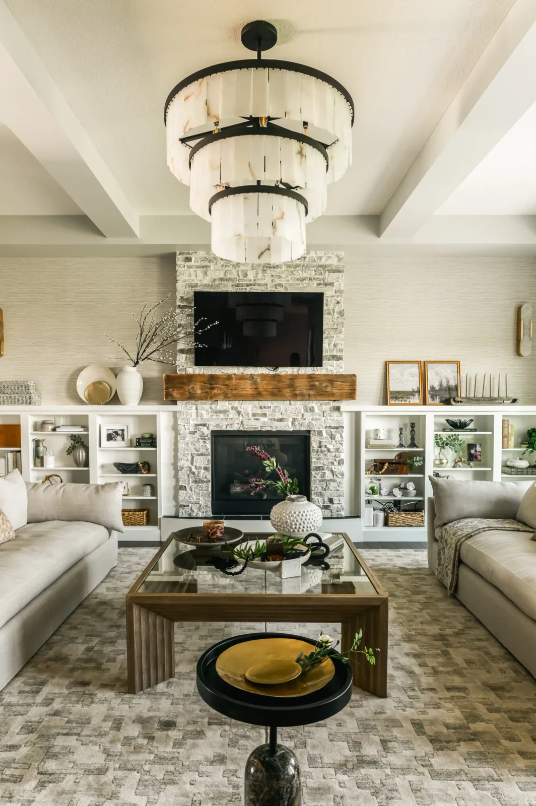 Finished Artesia De Winton living room with stone fireplace, custom millwork, reclaimed wood mantel and textured finishes