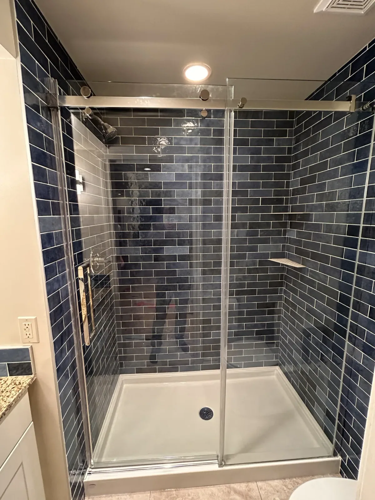 Calgary bathroom renovation with blue subway shower tiles