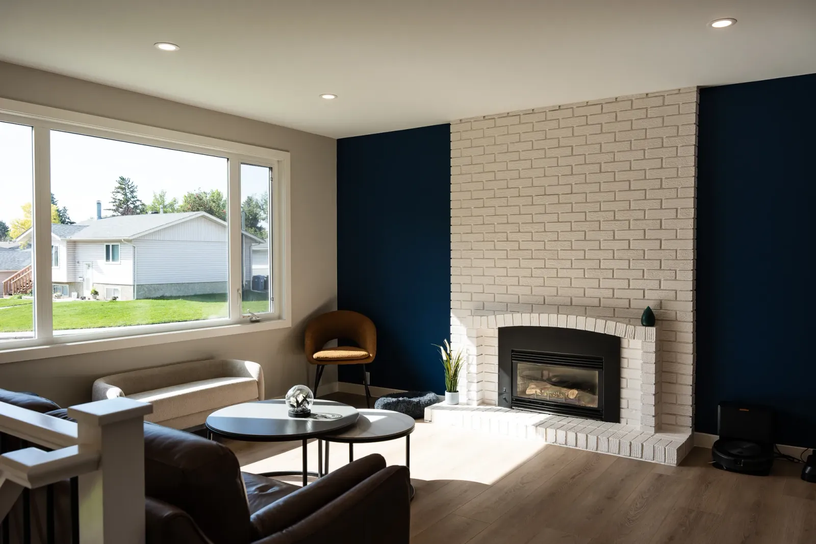 White brick fireplace anchoring a stunning living room remodel in Calgary, Alberta