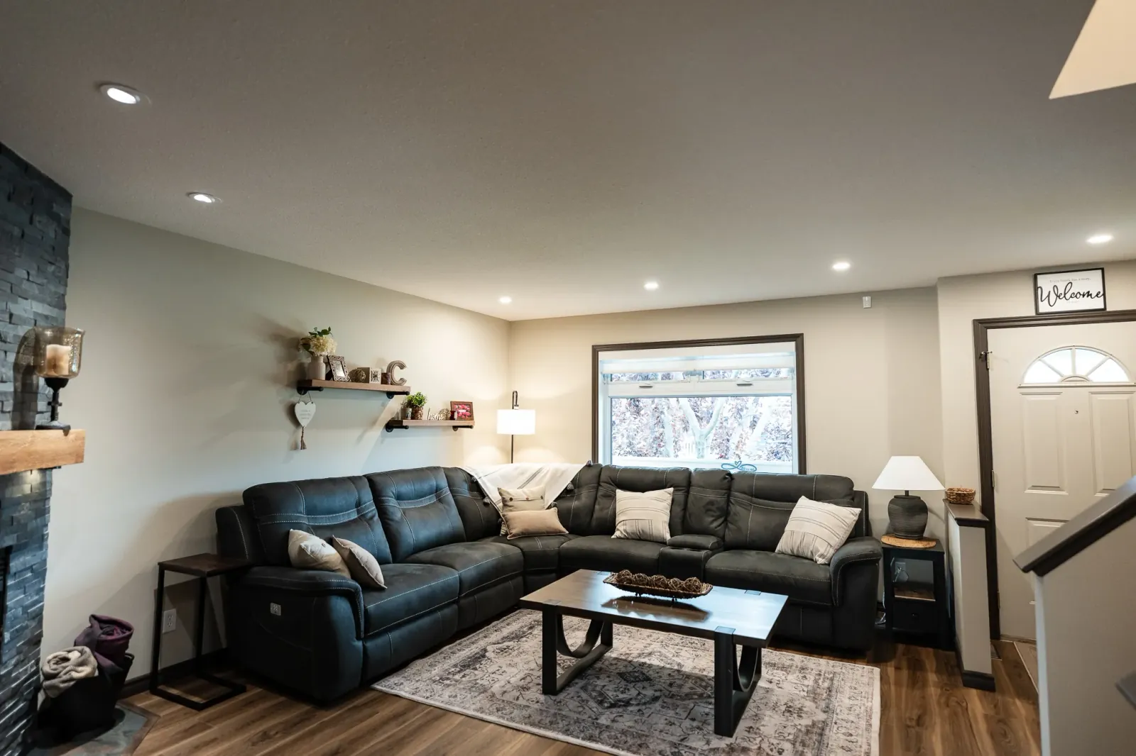 Renovated Calgary living room with warm neutral finishes, updated flooring and comfortable seating