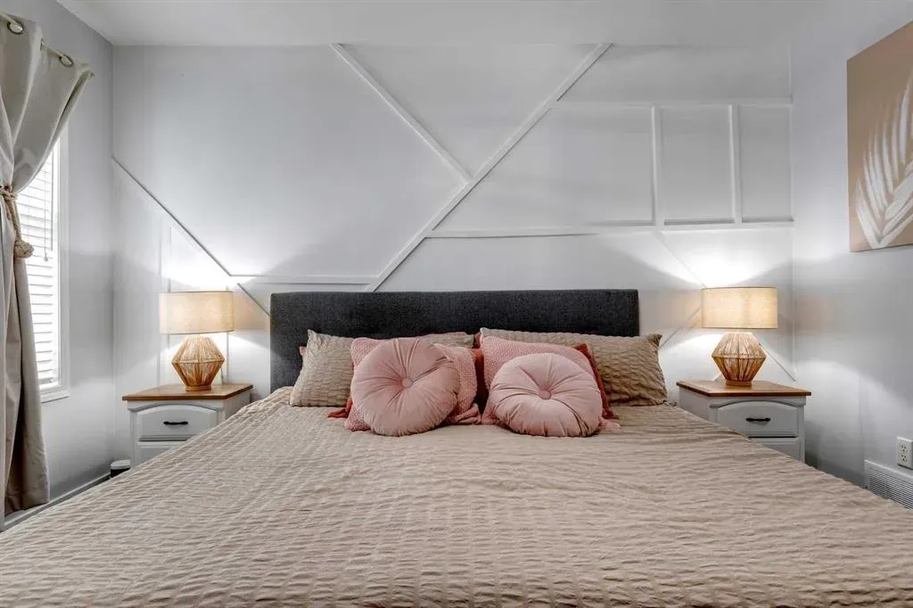 Textured details enhance a serene basement guest bedroom in a Calgary home renovation